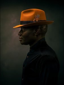 Wayne Höecherl - Portrait with an orange hat.