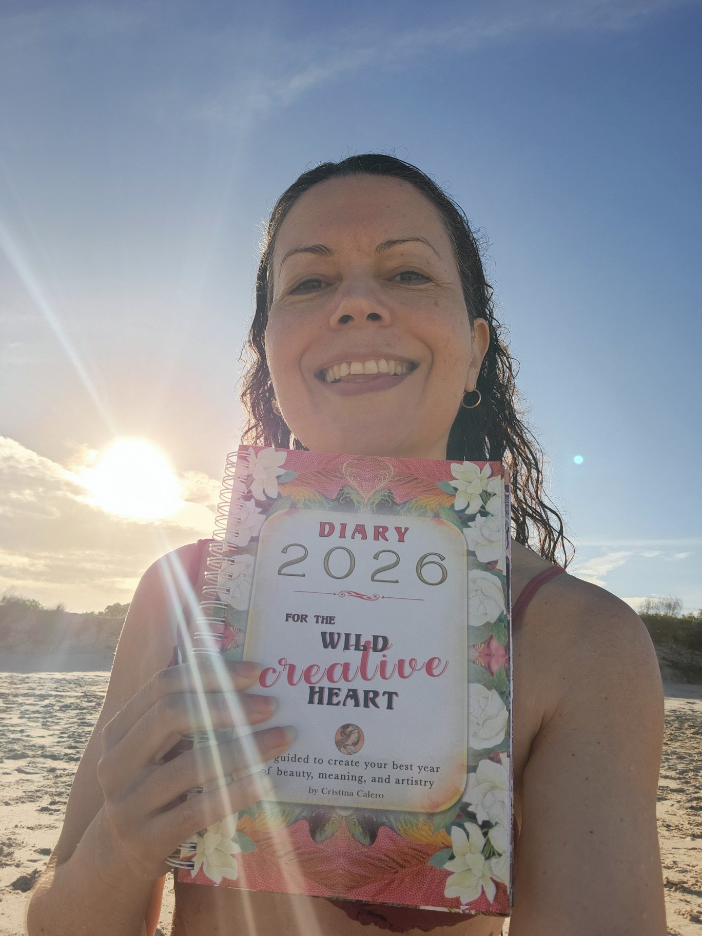 Cristina Calero on the beach with her 2026 DIARY for the wild, creative heart